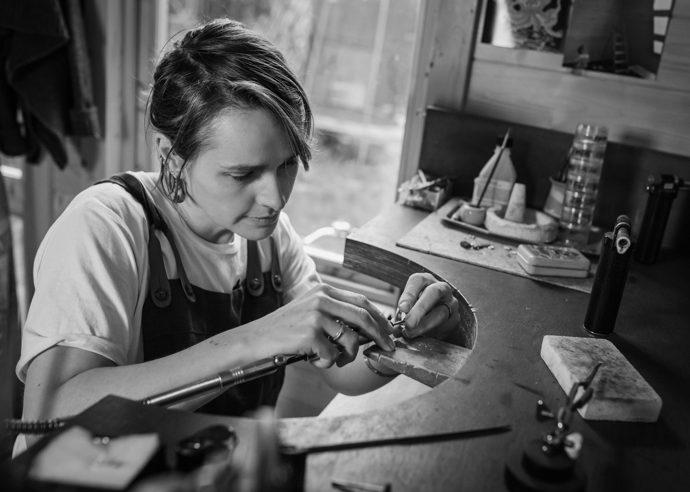 independent jeweller Issy White at her workbench making bespoke jewellery.