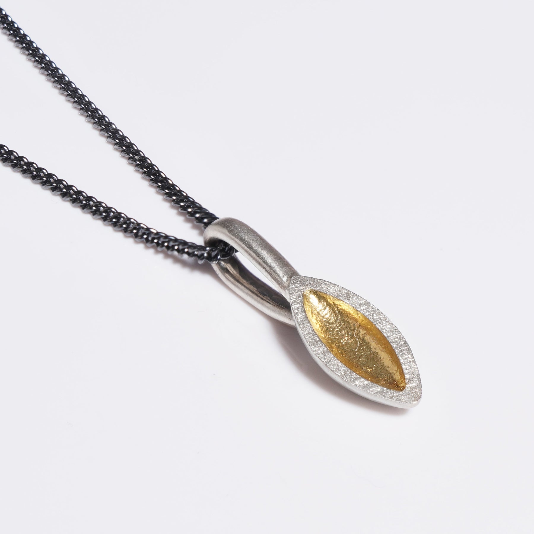Silver seed pod shaped pendant with oxidised chain
