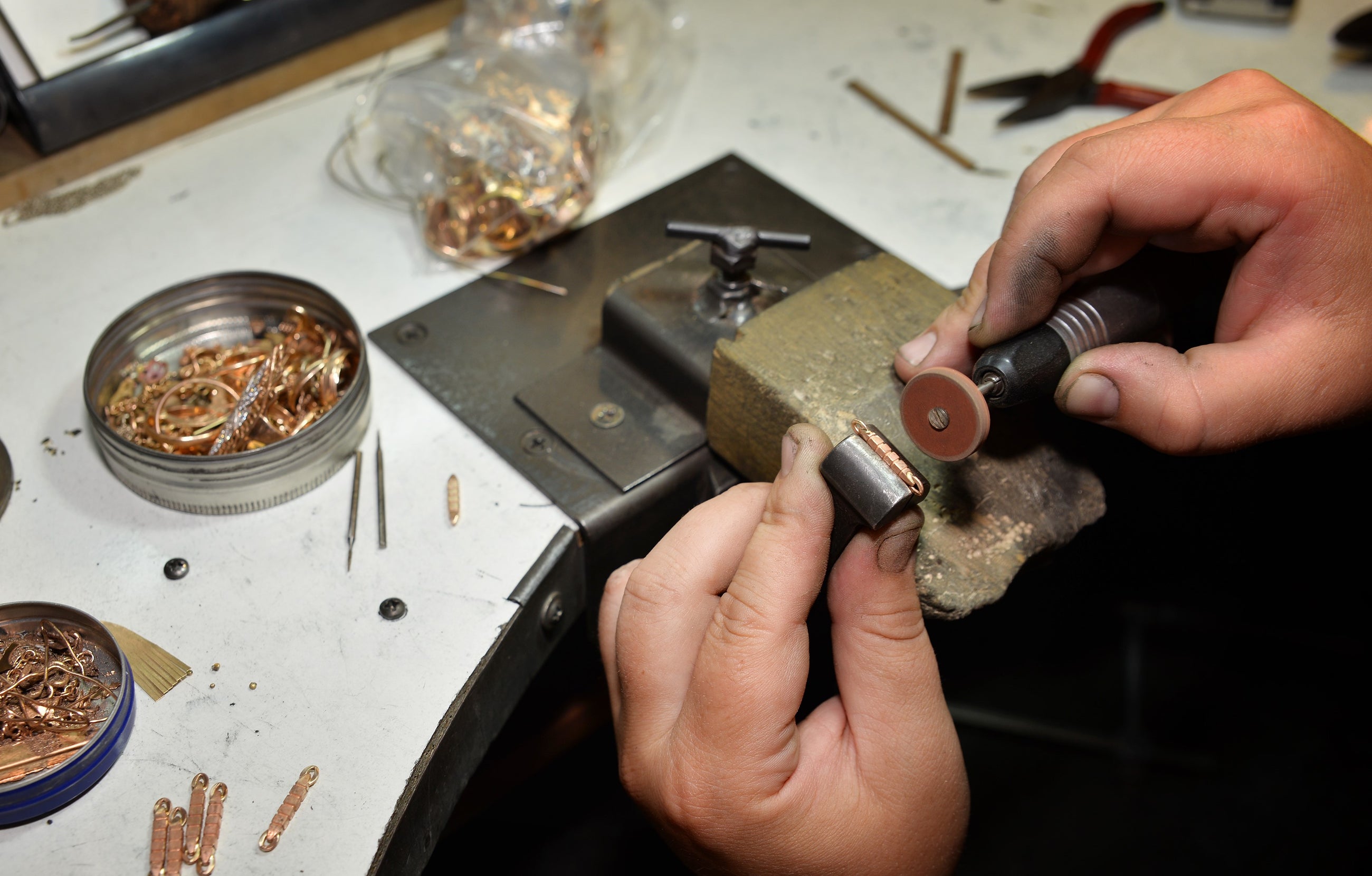 An Independent jeweller making a rose gold necklace by hand.