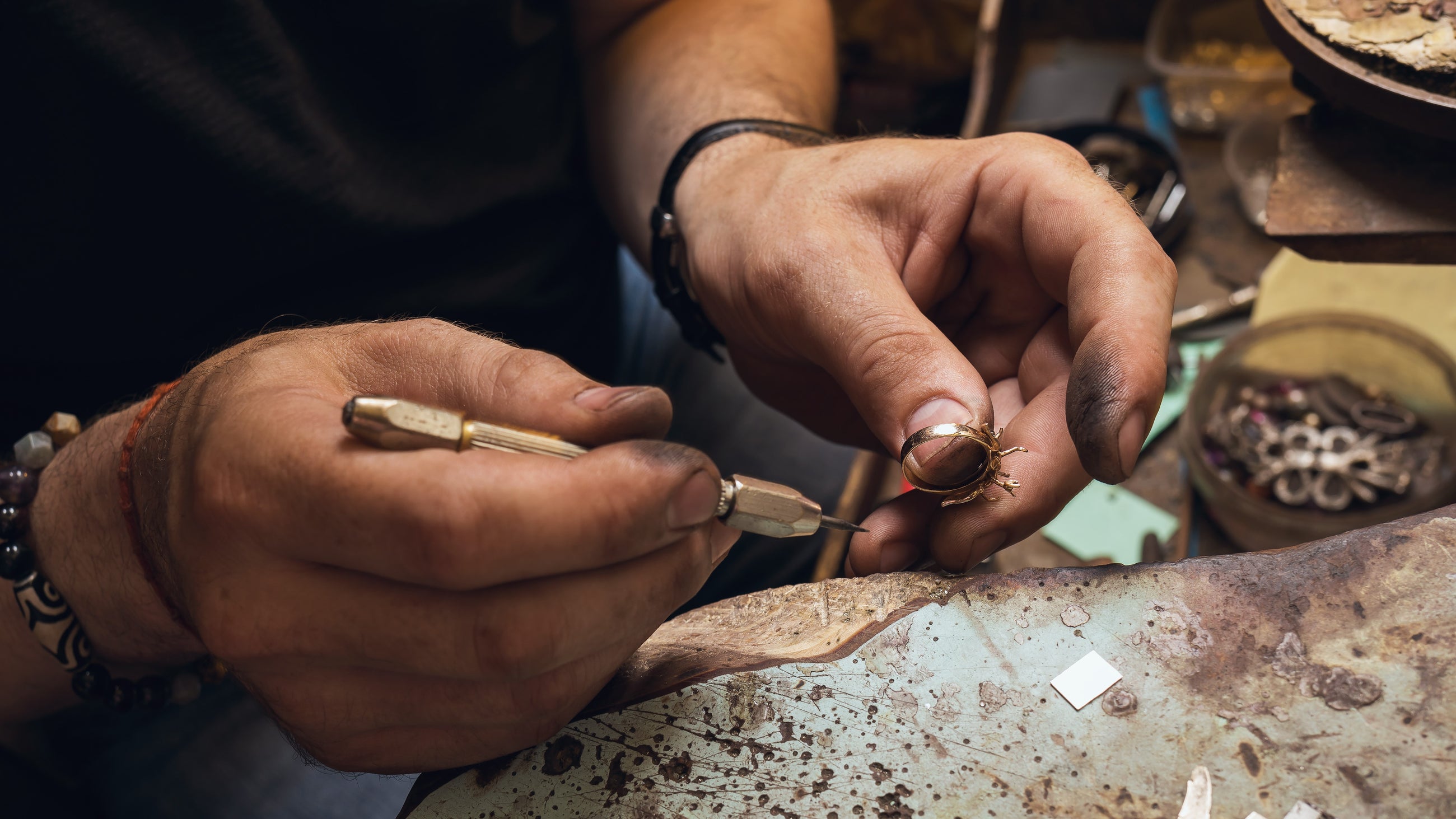 An Independent jeweller making a gold diamond ring by hand.