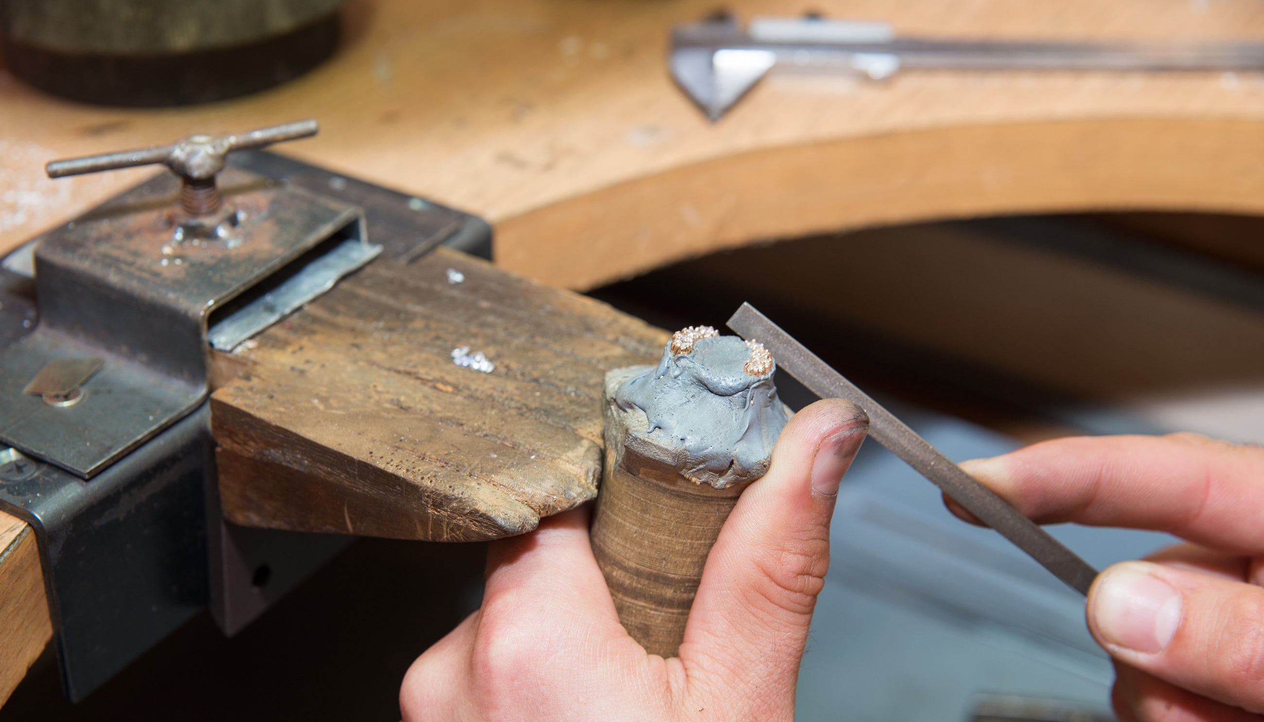 An Independent jeweller making a pair of diamond earrings by hand.