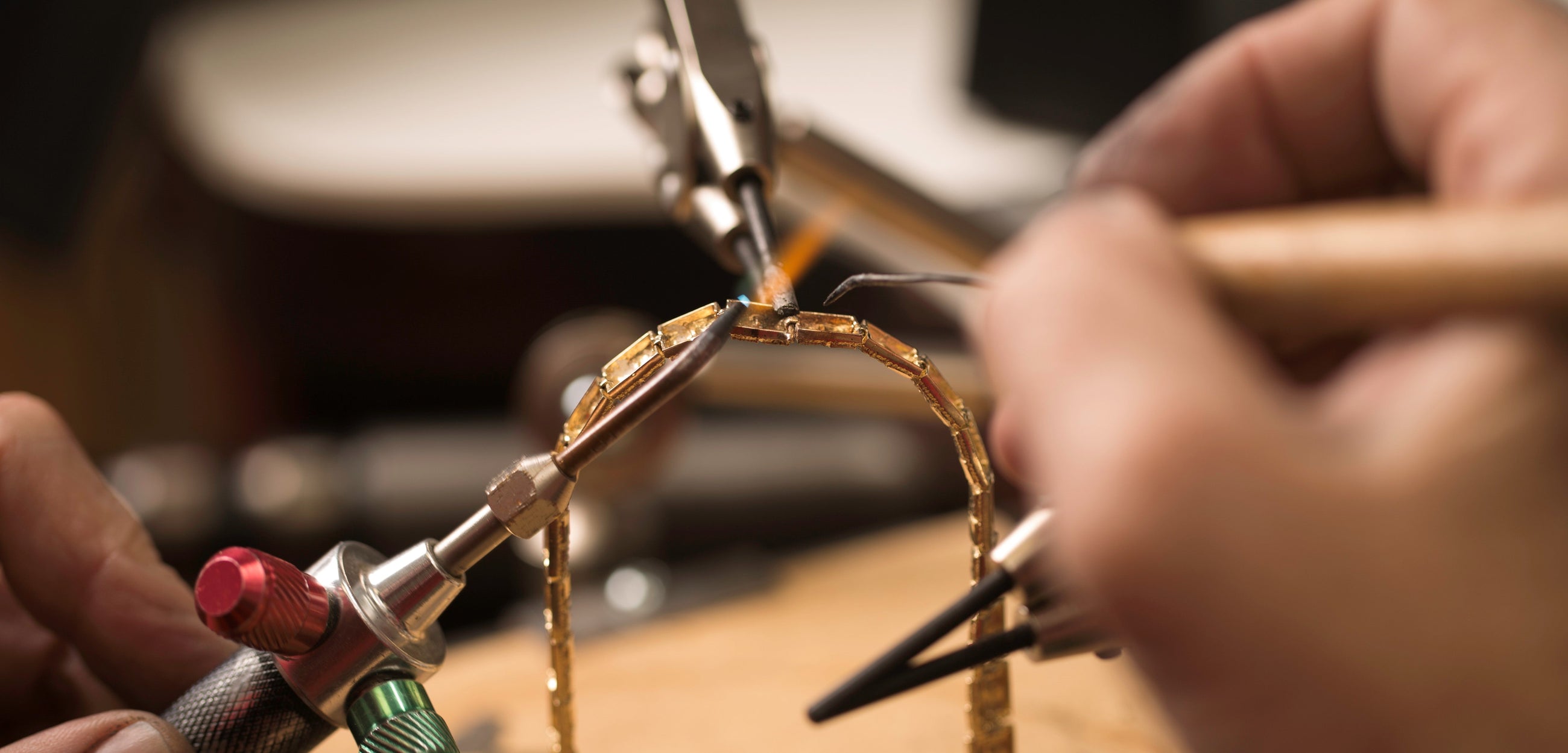 An Independent jeweller making a gold bracelet by hand.