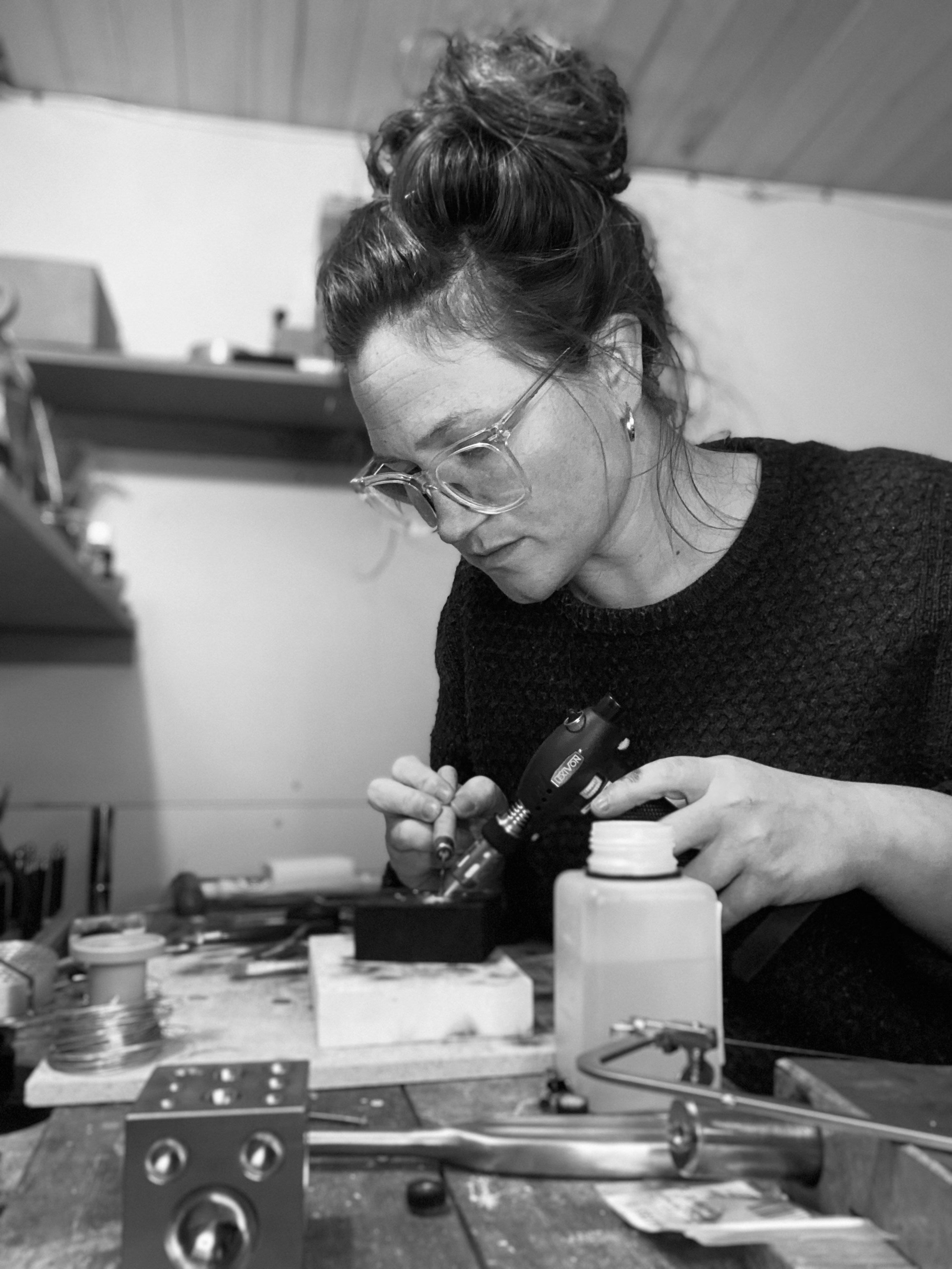 Tide & Trove founder Daisy Munn firing a bespoke engagement ring at her workbench