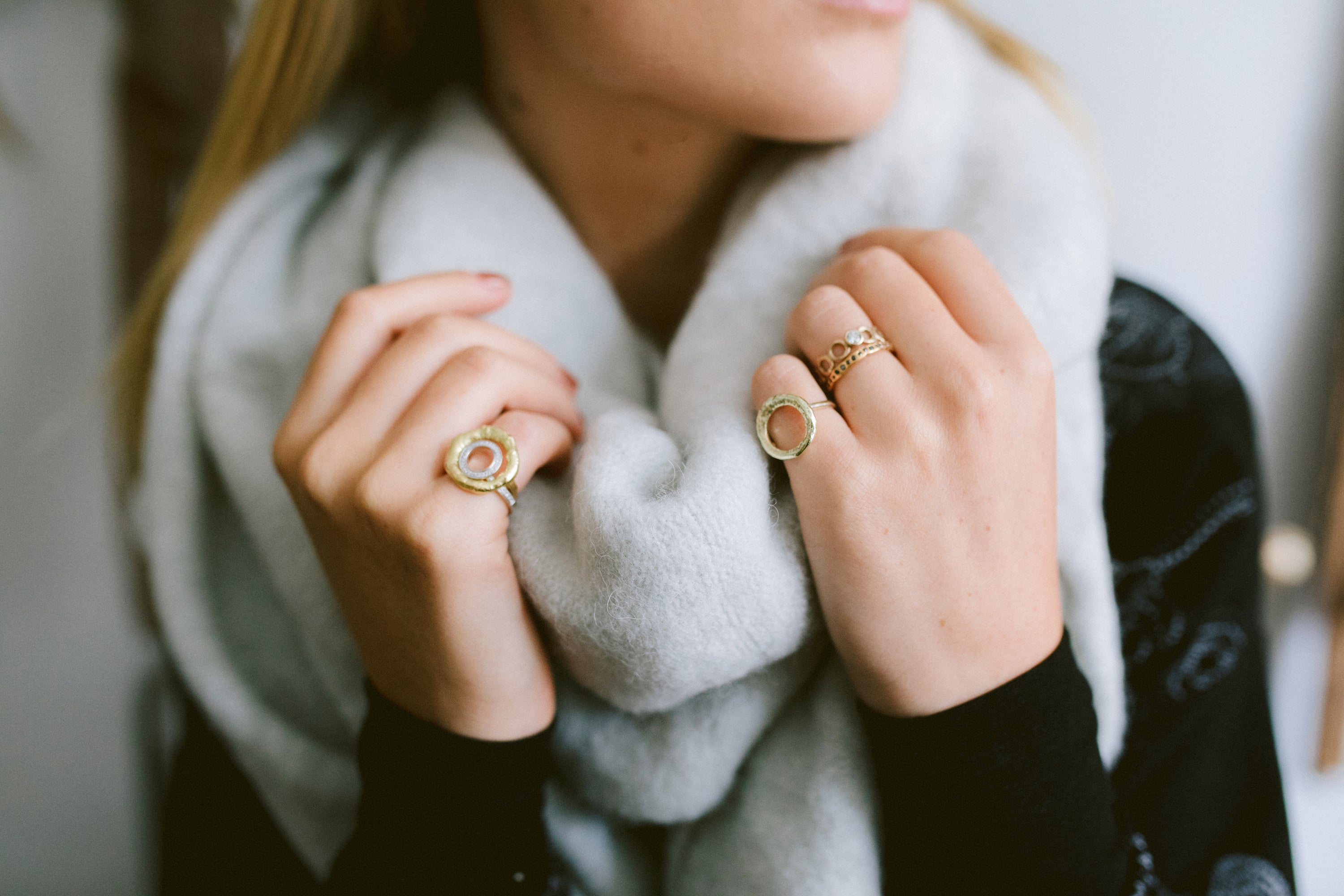 Woman wearing grey scarf and bespoke jewellery made by Erin Cox in Devon.