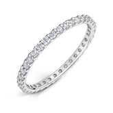 Round Brilliant cut diamonds set all around a 1.5mm white gold band in a claw style setting on a white background.
