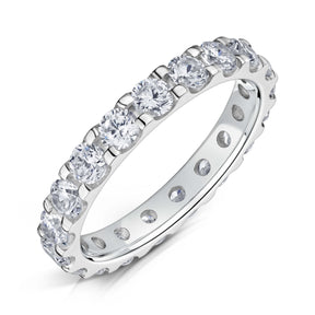 Round Brilliant cut diamonds set all around a 3.0mm white gold band in a claw style setting on a white background.