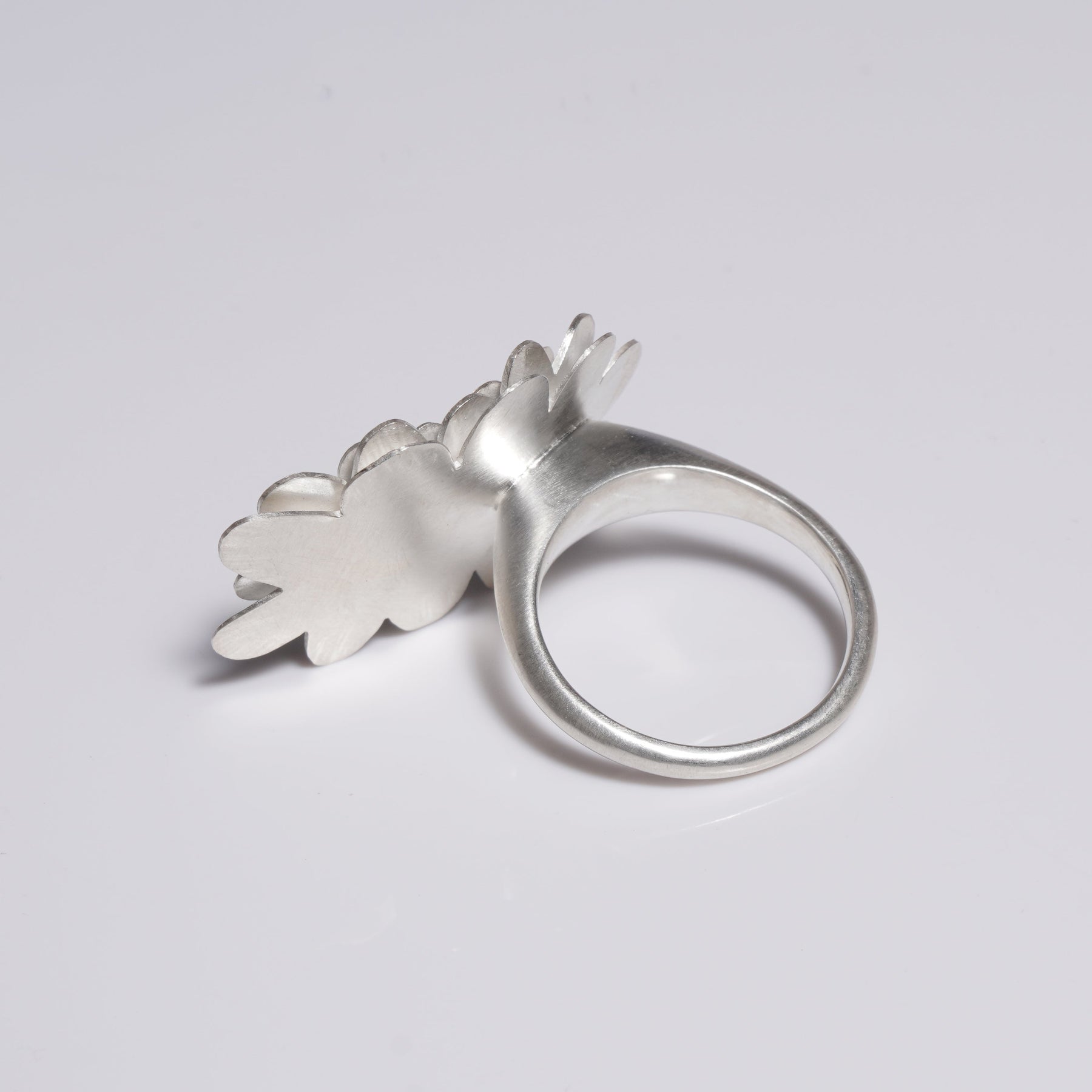Layered flower sterling silver ring with sapphire set in gold in reverse
