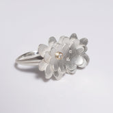 sterling silver abstract flower ring with three diamonds, one set in gold