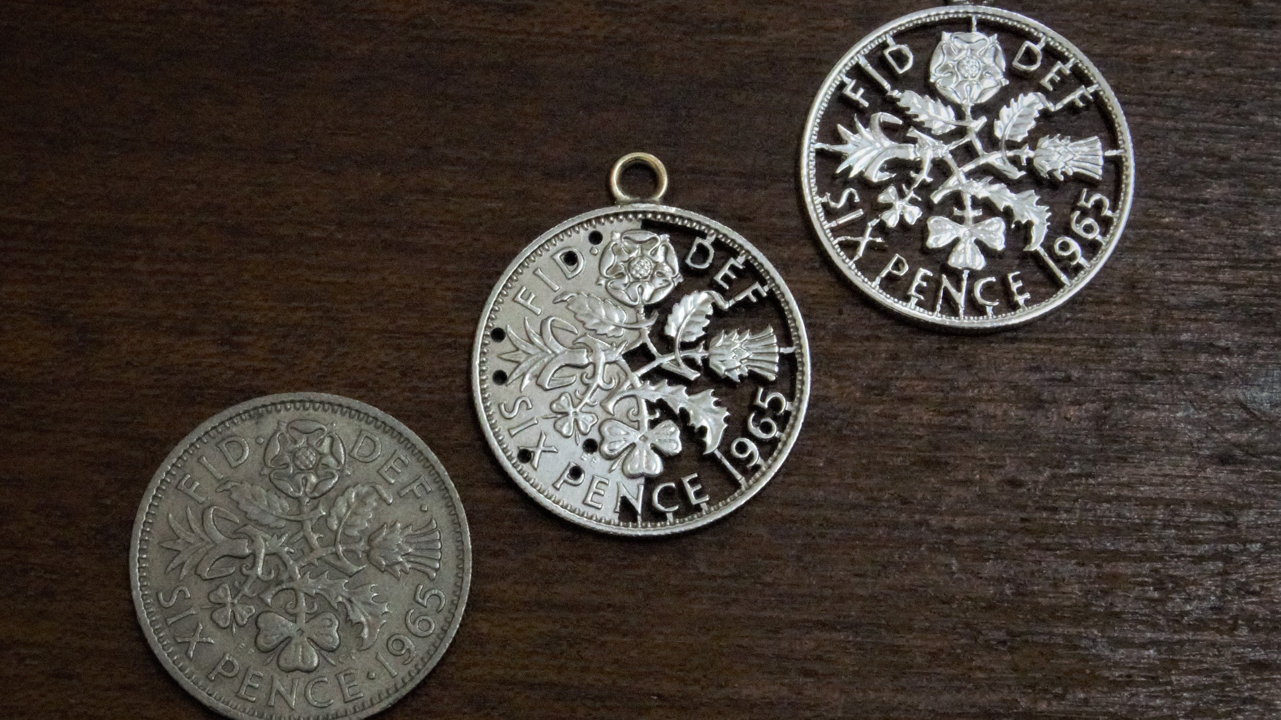 Three coins at different stages of manufacture, being turned into bespoke bridal jewellery by Coin Design