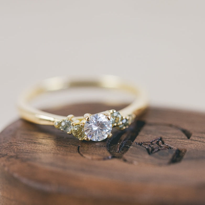 Moissanite and Green Sapphire Scatter Shoulder Engagement Ring