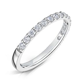Round Brilliant cut diamonds set half way around a 2.0mm white gold band in a claw style setting on a white background.