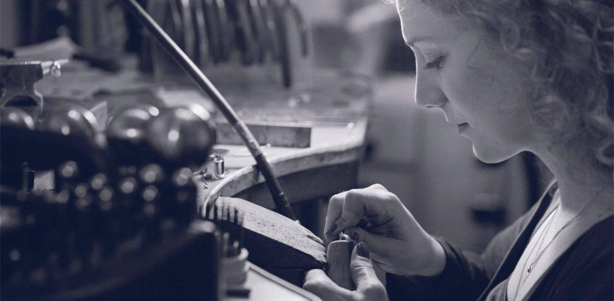 Independent jeweller Erin Cox crafting a bespoke engagement ring at her workbench in Devon