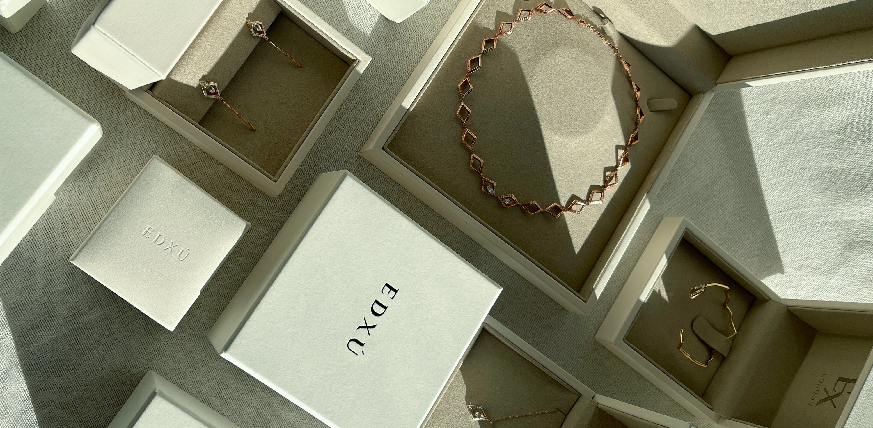 Variety of bespoke bridal jewelery in boxes, made by Independent jeweller EDXU