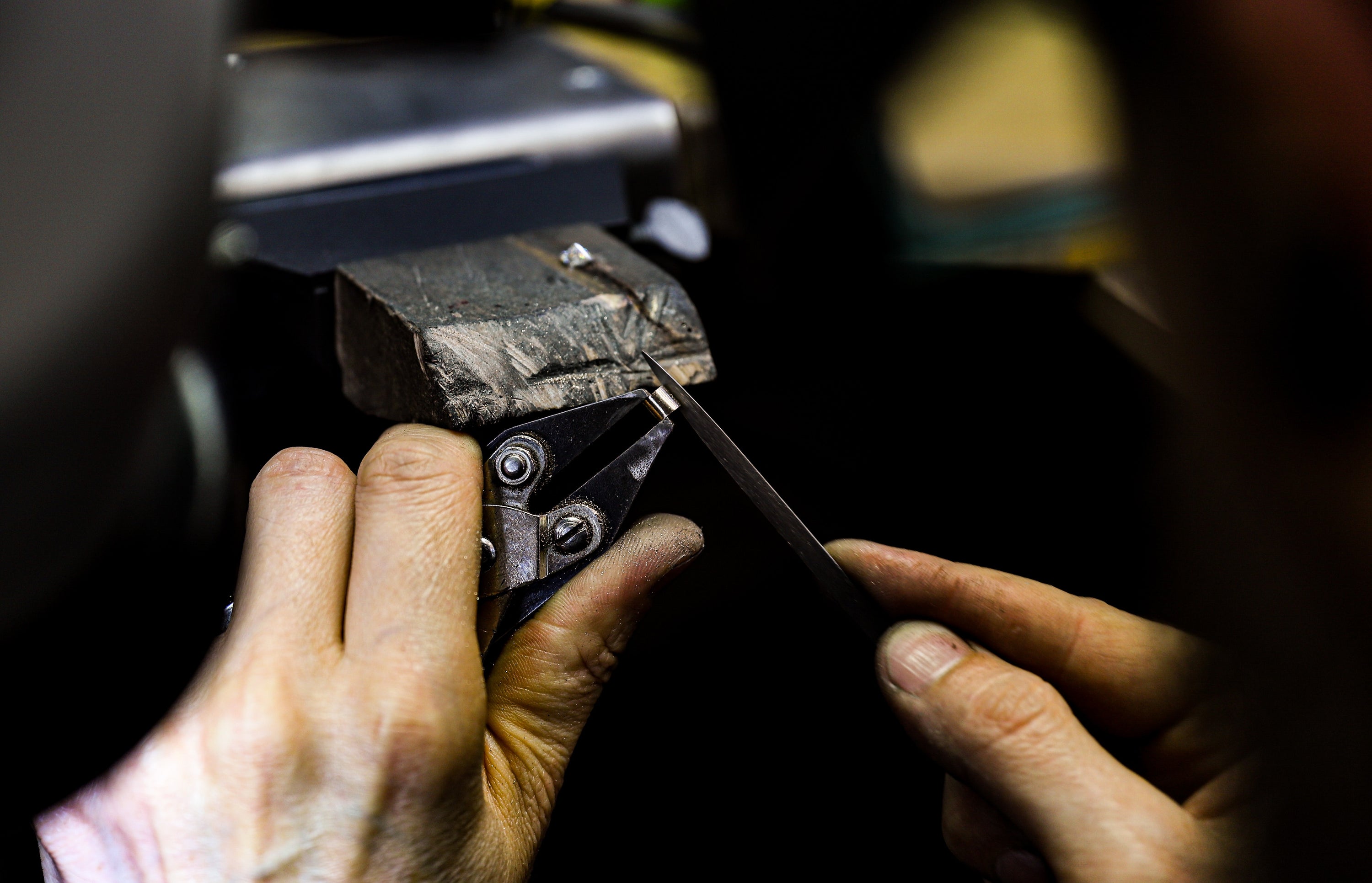 Close up shot of an independent jeweller filing a bespoke engagement ring